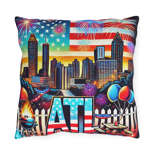 A colorful Atlanta-themed throw pillow featuring the city skyline with tall buildings, an American flag backdrop, and fireworks lighting up the sky. The bottom design includes bold "ATL" lettering with stars and stripes, picnic tables, balloons, a grill with flames, and backyard party elements. Perfect for patriotic holidays, Atlanta celebrations, or summer outdoor décor.