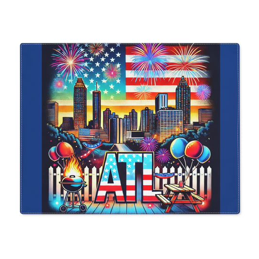 A colorful Atlanta-themed placemat featuring the city skyline with tall buildings, a large American flag backdrop, and bursts of vibrant fireworks. The design includes the bold "ATL" lettering in stars and stripes, a flaming BBQ grill, balloons, picnic tables, and festive backyard elements. Perfect for 4th of July celebrations, summer BBQs, and Atlanta-themed gatherings.