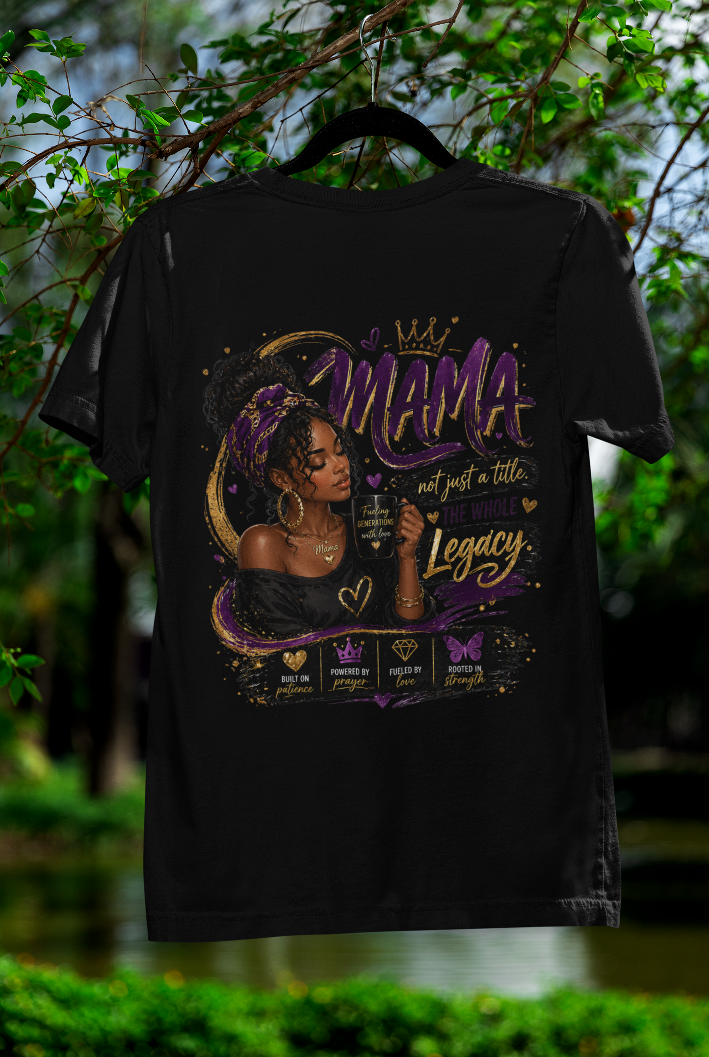 Black t-shirt with a graphic design featuring a woman and text, hanging against a natural background.