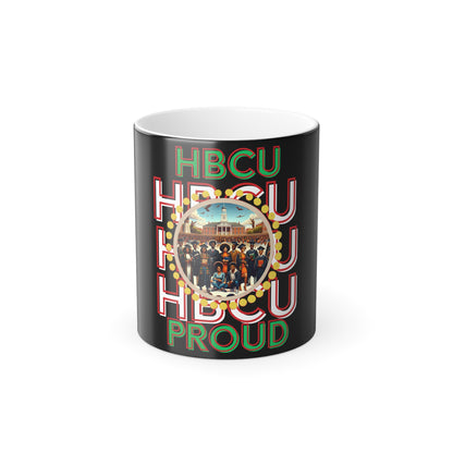 Black ceramic coffee mug featuring bold red, green, and white text that reads 'HBCU PROUD,' with a circular design in the center showcasing a historic HBCU campus and a diverse group of graduates in vibrant attire, surrounded by a decorative gold border.
