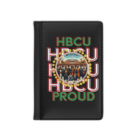 Black passport holder featuring bold red, green, and white text that reads 'HBCU PROUD.' The center showcases a circular design with a historic HBCU campus in the background and a diverse group of graduates in traditional attire, surrounded by a decorative gold border.