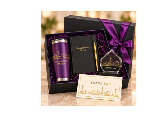 Las Vegas speaker appreciation gift box with purple tumbler, black journal, gold pen, faceted thank-you keepsake, and card, finished with purple ribbon.