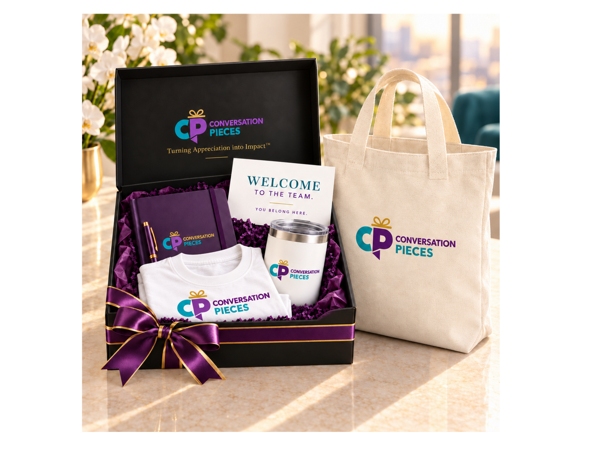 Conversation Pieces Standard welcome kit with a white branded T-shirt, purple notebook and pen, white tumbler, and welcome card in a black gift box with purple-and-gold ribbon, beside a linen-colored branded tote.
